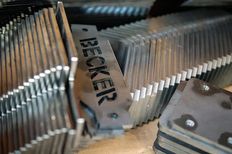 Laser-cut Becker sheet-metal parts, stacked after fabrication