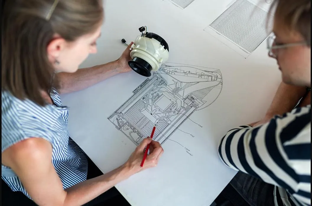 Engineers reviewing a technical drawing