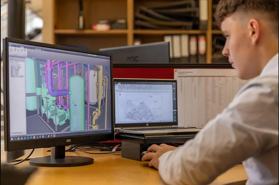 Engineer designing an equipment layout in 3D CAD